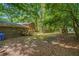 Brick home featuring a wooden deck and spacious partially wooded backyard at 2544 Peyton Woods Sw Trl, Atlanta, GA 30311