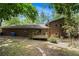Backyard of brick home with a wooden deck, mature trees and partially wooded at 2544 Peyton Woods Sw Trl, Atlanta, GA 30311