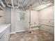 This unfinished basement laundry area features tile floor and storage at 2544 Peyton Woods Sw Trl, Atlanta, GA 30311