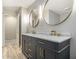 This double vanity bathroom features light wood floors and gold fixtures at 2544 Peyton Woods Sw Trl, Atlanta, GA 30311