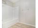 This bathroom features a combination shower-tub and wood-look floors at 2544 Peyton Woods Sw Trl, Atlanta, GA 30311