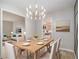 Bright dining room featuring modern chandelier and adjacent living room and kitchen views at 2544 Peyton Woods Sw Trl, Atlanta, GA 30311