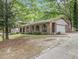 Well-maintained brick home with a two-car garage, arched entryway, and landscaped front yard at 2544 Peyton Woods Sw Trl, Atlanta, GA 30311