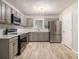 Modern kitchen with stainless steel appliances, gray cabinets, and stylish backsplash at 2544 Peyton Woods Sw Trl, Atlanta, GA 30311