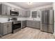 Well-equipped kitchen with stainless steel appliances, grey cabinetry, and a light, airy feel at 2544 Peyton Woods Sw Trl, Atlanta, GA 30311