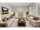 Cozy living room featuring neutral tones, a large sofa, and ample natural light at 2544 Peyton Woods Sw Trl, Atlanta, GA 30311