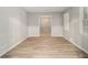 Spacious room with wooden flooring, neutral walls, and ample natural light at 2544 Peyton Woods Sw Trl, Atlanta, GA 30311