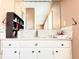 Bathroom with a large mirror, white countertop and cabinets, and neutral colored walls at 2563 Hamill Dr, Buford, GA 30519
