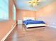 Comfortable bedroom with hardwood floors, a ceiling fan, a bed, and plenty of natural light at 2563 Hamill Dr, Buford, GA 30519