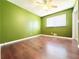 Empty bedroom featuring hardwood floors, green walls, and a ceiling fan at 2563 Hamill Dr, Buford, GA 30519