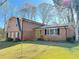 Charming two-story home with brick and siding exterior, complemented by a well-maintained front yard and mature trees at 2563 Hamill Dr, Buford, GA 30519
