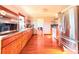 Spacious kitchen with stainless steel appliances, wooden cabinets, and hardwood flooring throughout the room at 2563 Hamill Dr, Buford, GA 30519