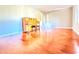 Bright living room featuring polished hardwood floors, a vintage piano, and ample natural light at 2563 Hamill Dr, Buford, GA 30519