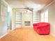 Cozy living room with a brick fireplace, built-in bookshelves, a ceiling fan, and a comfortable sofa at 2563 Hamill Dr, Buford, GA 30519