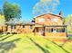 View of the back exterior featuring the siding and brick combination with a screened in porch at 2563 Hamill Dr, Buford, GA 30519