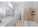 Bathroom featuring double sinks, a soaking tub, and a walk-in closet access at 400 17Th Nw St # 1113, Atlanta, GA 30363