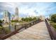 A picturesque bridge in front of a pond, surrounded by city buildings and lush greenery at 400 17Th Nw St # 1113, Atlanta, GA 30363