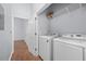 Bright laundry room with modern washer, dryer, and shelving at 400 17Th Nw St # 1113, Atlanta, GA 30363