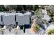An aerial view of a well-maintained townhome featuring its roof, a landscaped yard, and mature trees at 1 Mooregate Sq, Atlanta, GA 30327