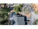 An aerial view of a well-maintained townhome with mature trees, black roof and neatly paved driveway at 1 Mooregate Sq, Atlanta, GA 30327
