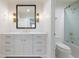 Bathroom featuring white marble counters, vanity, gold hardware, and tiled shower at 1 Mooregate Sq, Atlanta, GA 30327
