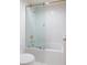 Modern bathroom with glass shower doors, white subway tiles, and gold accents at 1 Mooregate Sq, Atlanta, GA 30327