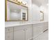 Bright bathroom with double vanity, marble countertops, and decorative mirrors, offering a spa-like experience at 1 Mooregate Sq, Atlanta, GA 30327