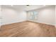 Sun-filled bedroom with gleaming hardwood floors and natural light from the shuttered window at 1 Mooregate Sq, Atlanta, GA 30327