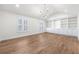 Light-filled bedroom with hardwood flooring and custom built-in shelving at 1 Mooregate Sq, Atlanta, GA 30327