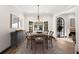 Dining room featuring chandelier, wood table, and natural light from black framed windows at 1 Mooregate Sq, Atlanta, GA 30327