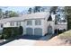 Inviting two-story townhome with teal accents, a well-maintained lawn, and a paved driveway at 1 Mooregate Sq, Atlanta, GA 30327