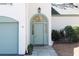 Charming home exterior with a pale teal front door, garage, and an arched transom window above the door at 1 Mooregate Sq, Atlanta, GA 30327