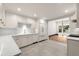 Bright kitchen with white cabinets, marble countertops, and gold fixtures at 1 Mooregate Sq, Atlanta, GA 30327