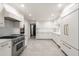 Well-lit kitchen features stainless steel appliances, custom cabinets, marble countertops, and marble backsplash at 1 Mooregate Sq, Atlanta, GA 30327