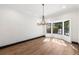 Sunlit living room with hardwood floors, crown molding, and modern chandelier at 1 Mooregate Sq, Atlanta, GA 30327