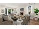 Living room with fireplace, modern furnishings, and bright, natural light at 1 Mooregate Sq, Atlanta, GA 30327