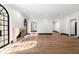 Bright living room with fireplace, hardwood floors, and unique arched black frame windows at 1 Mooregate Sq, Atlanta, GA 30327