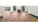 Expansive living area featuring hardwood floors and a fireplace, illuminated by natural light from large arched windows at 1 Mooregate Sq, Atlanta, GA 30327