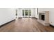 Open living room featuring hardwood flooring, a fireplace, and black framed windows at 1 Mooregate Sq, Atlanta, GA 30327