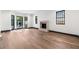 Light-filled living room with fireplace, hardwood floors, and black framed windows at 1 Mooregate Sq, Atlanta, GA 30327