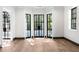 Spacious living room with hardwood floors, white walls, and black framed windows at 1 Mooregate Sq, Atlanta, GA 30327