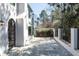 An outdoor patio featuring an iron gate, concrete perimeter wall, and stone pavers at 1 Mooregate Sq, Atlanta, GA 30327