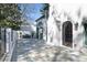 An outdoor patio featuring an iron gate, concrete perimeter wall, and stone pavers at 1 Mooregate Sq, Atlanta, GA 30327