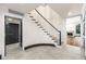 Elegant staircase with hardwood steps, white risers, and a black handrail complemented by neutral tile floors at 1 Mooregate Sq, Atlanta, GA 30327