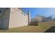 A spacious backyard with a privacy fence and blooming tree sits next to a two-story home with a garage and vinyl siding at 116 Ventura Trl, Stockbridge, GA 30281