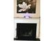 A fireplace features a mantle decorated with a floral picture and candles, creating a cozy focal point in the room at 116 Ventura Trl, Stockbridge, GA 30281