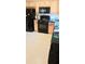 A kitchen features wooden cabinets, black appliances, and neutral flooring, presenting a functional cooking space at 116 Ventura Trl, Stockbridge, GA 30281