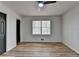 A light-filled bedroom offers wood-look floors, a modern ceiling fan and a paneled door at 4756 Fellsridge Dr, Stone Mountain, GA 30083