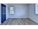 A light-filled bedroom offers wood-look floors, white walls and a navy blue door to match the room at 4756 Fellsridge Dr, Stone Mountain, GA 30083