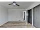 A light and airy bedroom offers wood-look floors, with many doors and a modern ceiling fan at 4756 Fellsridge Dr, Stone Mountain, GA 30083
